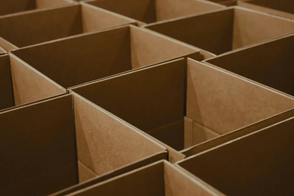 Overhead view of rows of empty cardboard boxes.